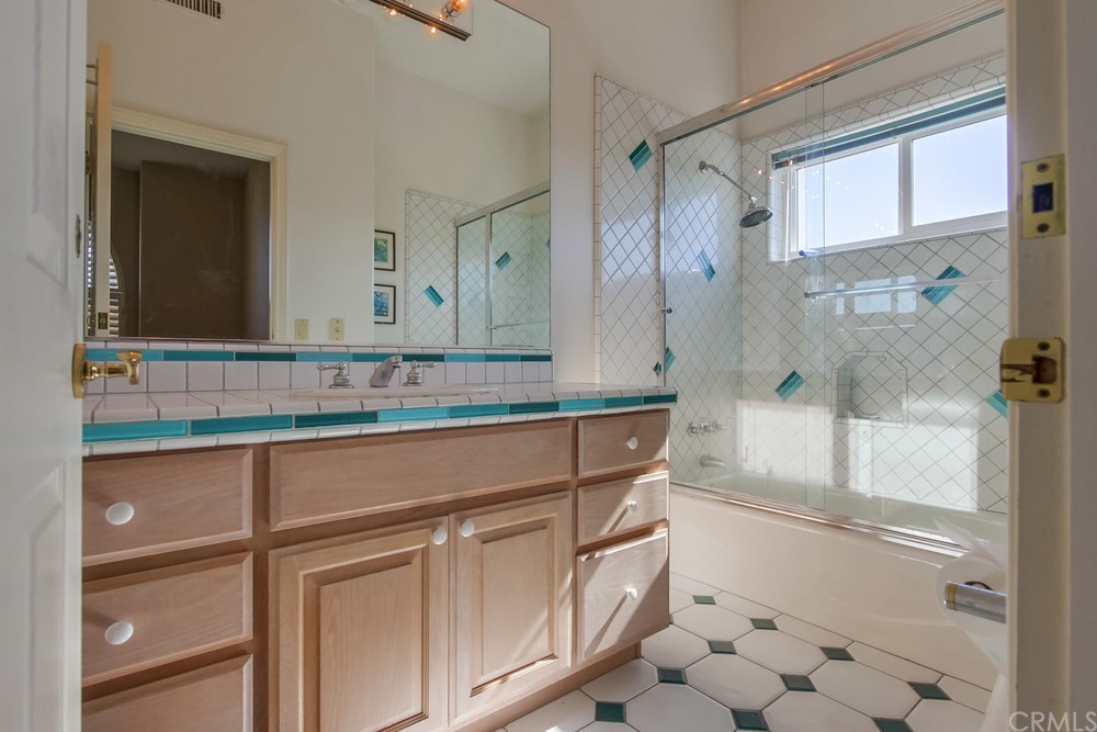 3036 Southwind Lane Vista, CA 92084 - Photo 33 of 45 a bathroom with a sink and a mirror