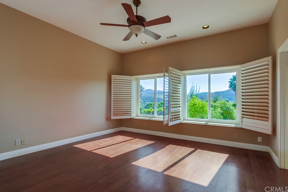 3036 Southwind Lane Vista, CA 92084 - Photo 34 of 45 a view of an empty room with wooden floor and a window