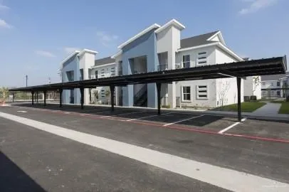 a front view of a house with a road