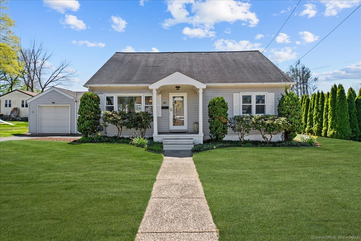 a front view of a house with a garden