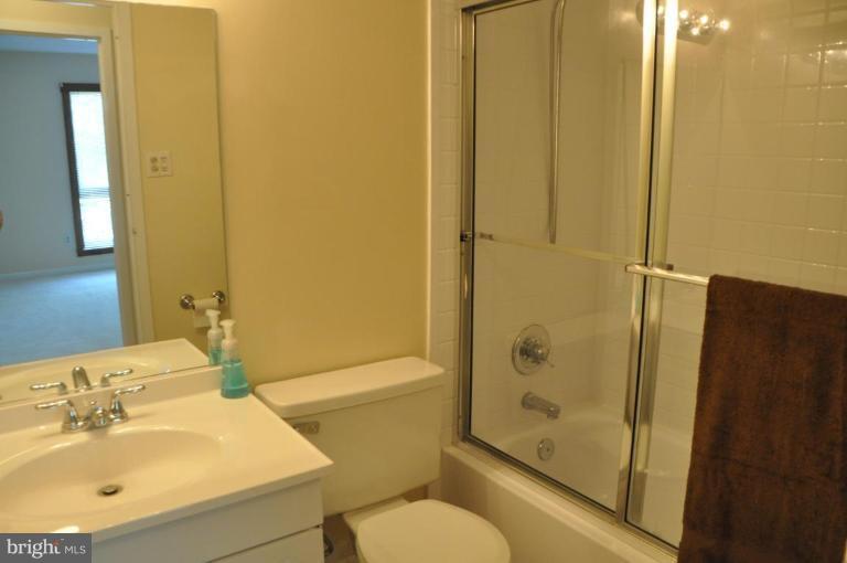 11240 Chestnut Grove Square, Unit 258 Reston, VA 20190 - Photo 11 of 19 a bathroom with a sink toilet and shower