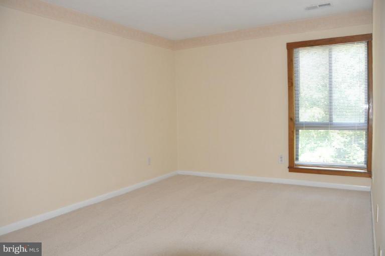 11240 Chestnut Grove Square, Unit 258 Reston, VA 20190 - Photo 12 of 19 an empty room with a window