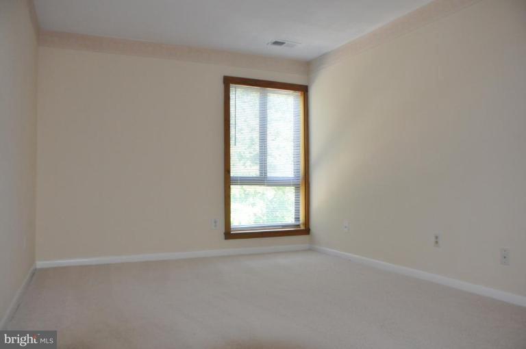 11240 Chestnut Grove Square, Unit 258 Reston, VA 20190 - Photo 14 of 19 an empty room with a window