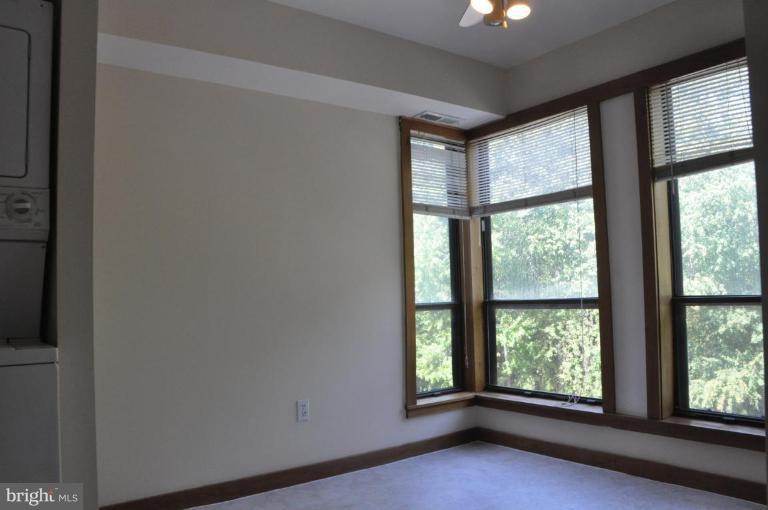 11240 Chestnut Grove Square, Unit 258 Reston, VA 20190 - Photo 4 of 19 a view of an empty room with a window