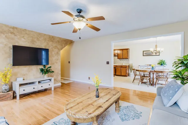 a dining room with furniture a large window and a chandelier