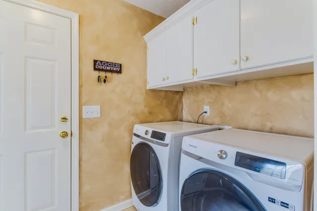 a view of a livingroom with a staircase and a ceiling fan