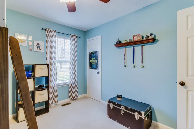 a bedroom with a bed and ceiling fan