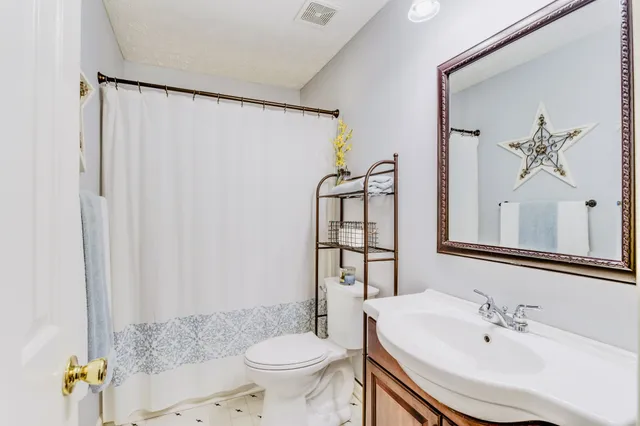 a bathroom with a shower and a sink