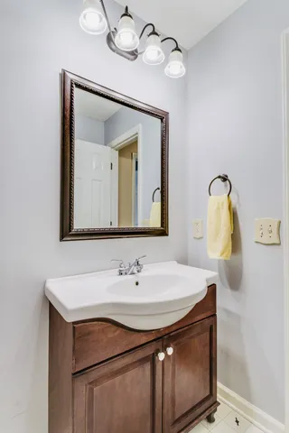 a bathroom with a sink vanity and a mirror