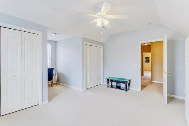 a backyard of a house with basket ball table and chairs