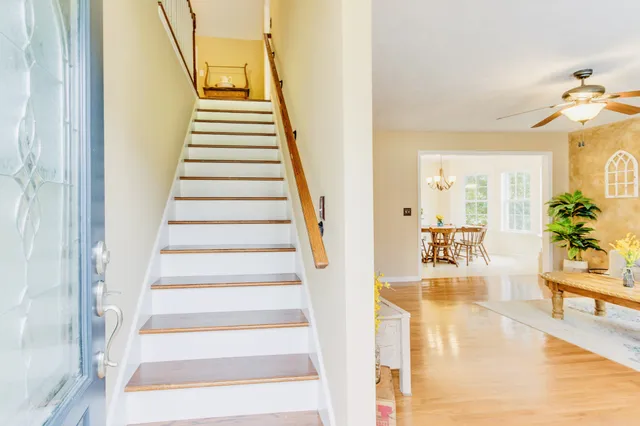 a living room with furniture and a chandelier