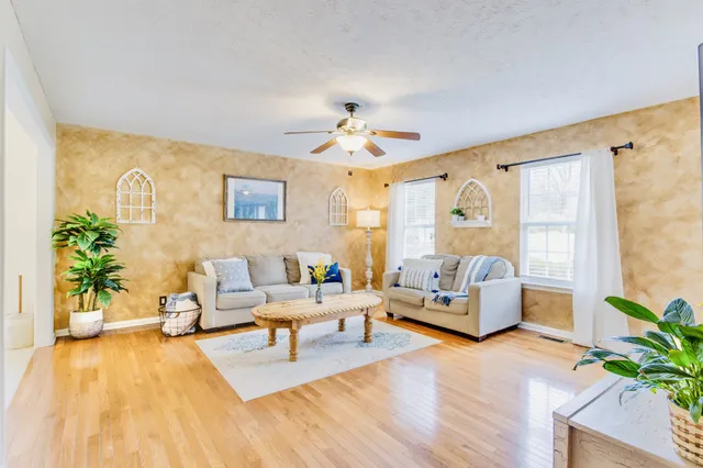 a living room with furniture and wooden floor