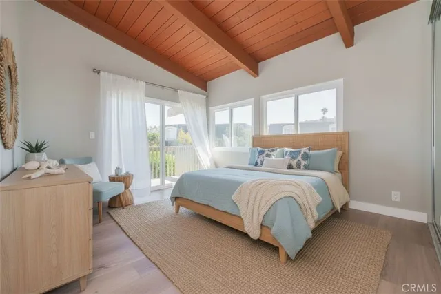 a bedroom with a bed and large windows