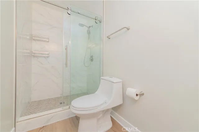 a bathroom with a toilet and shower