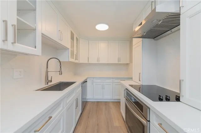 a kitchen with a sink and cabinets