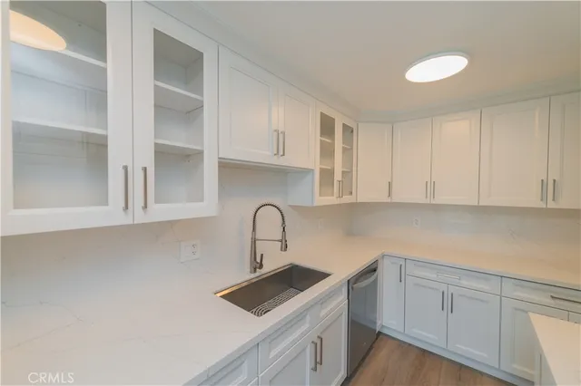 a kitchen with cabinets a sink and appliances
