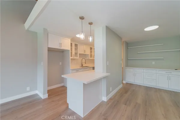 a view of a kitchen cabinets and wooden floor