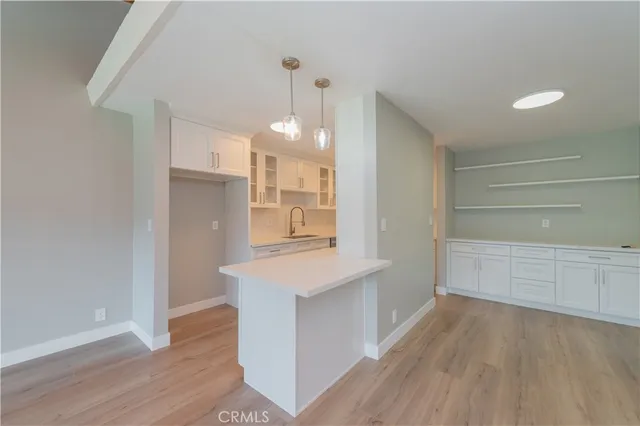 a view of a kitchen cabinets and wooden floor