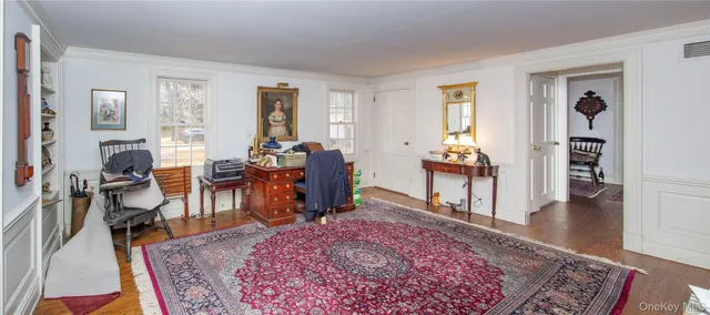 a view of a dining room with furniture and a window