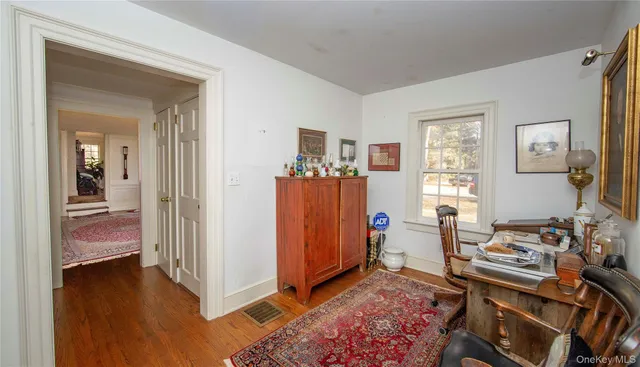 a living room with furniture a chandelier and a wooden floor
