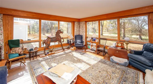 a living room with furniture windows and a flat screen tv