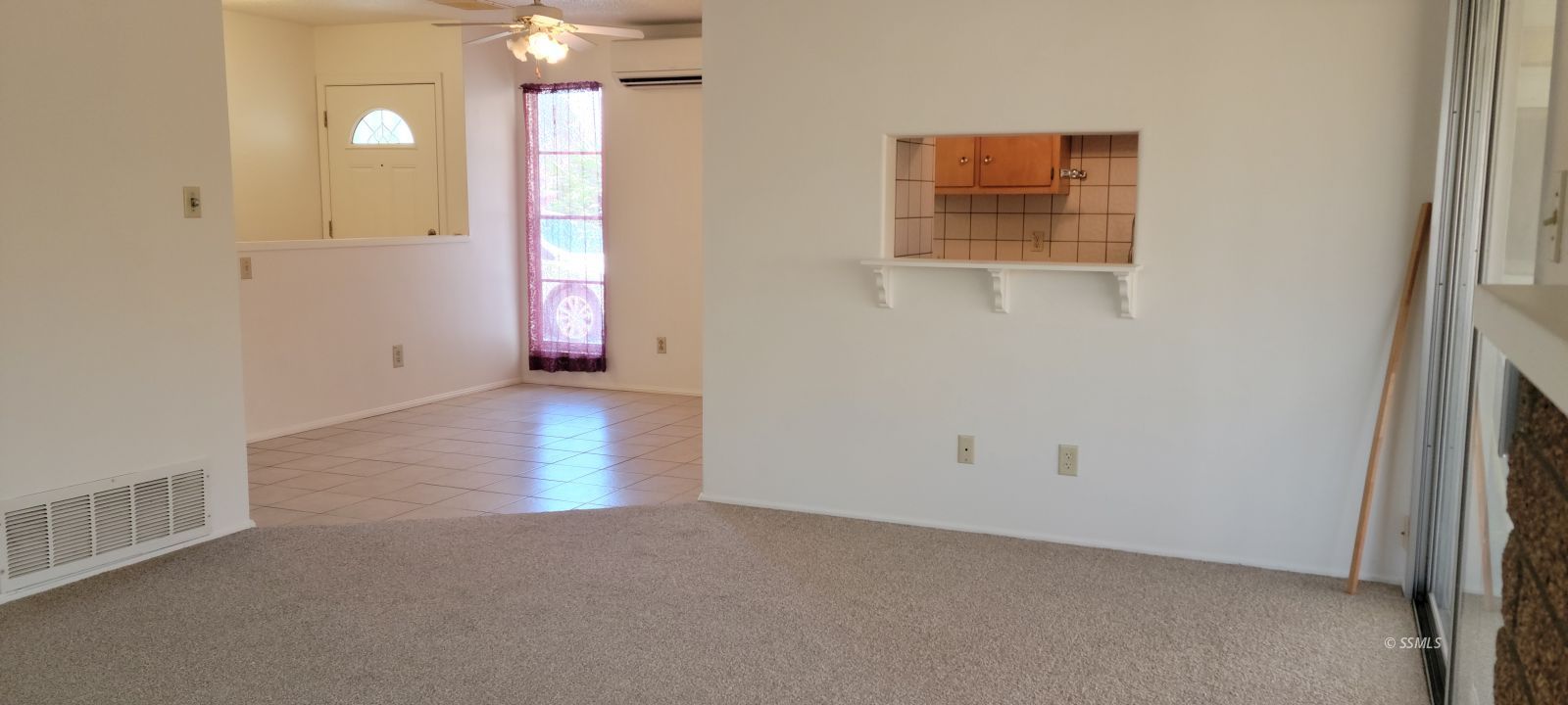 405 Karin Street Ridgecrest, CA 93555 - Photo 2 of 21 an empty room with windows and fan