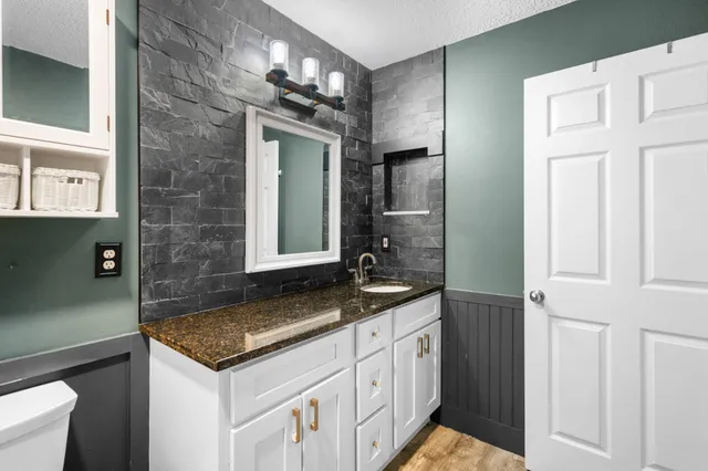 a bathroom with a sink and a mirror