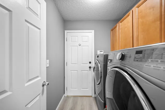 a view of a storage & utility room with dryer and washer