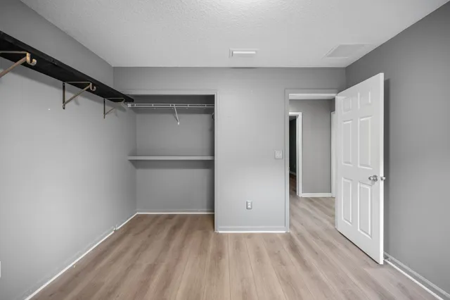 a view of a room with wooden floor