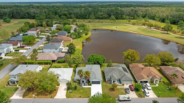 an aerial view of residential houses with outdoor space and swimming pool