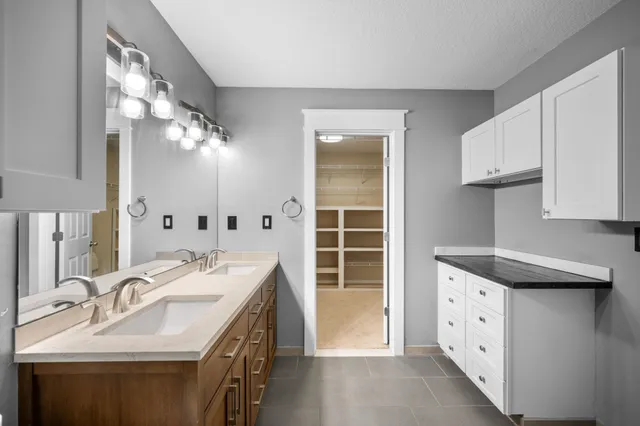 a bathroom with a sink double vanity and a mirror