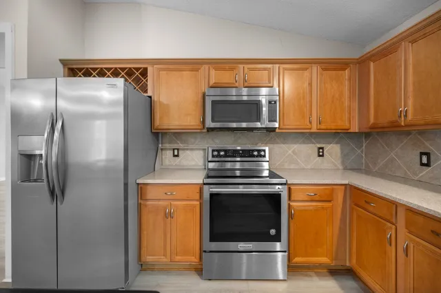 a kitchen with a stove microwave and refrigerator