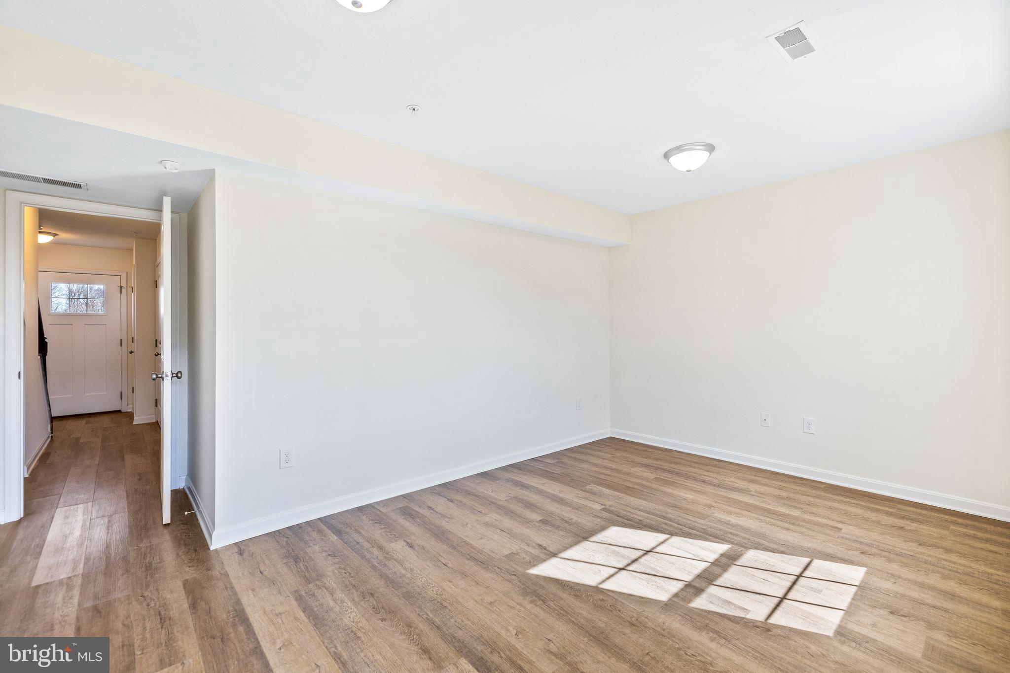0 H Street, Unit 108 Carlisle, PA 17013 - Photo 25 of 26 a view of an empty room and wooden floor