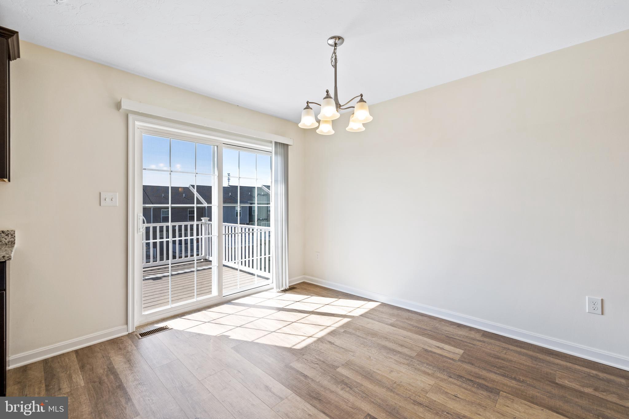0 H Street, Unit 108 Carlisle, PA 17013 - Photo 5 of 26 a view of empty room with wooden floor and fan