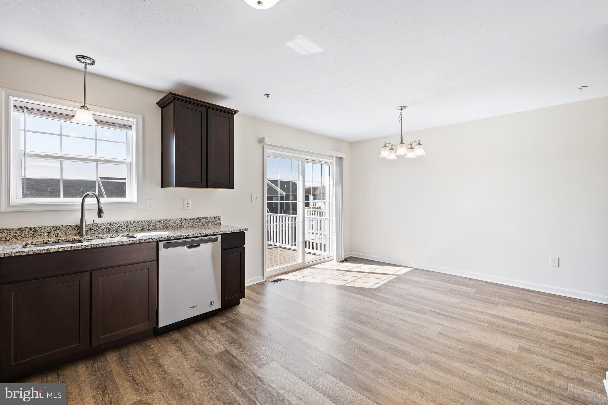 0 H Street, Unit 108 Carlisle, PA 17013 - Photo 7 of 26 a large kitchen with granite countertop a large window and wooden floor
