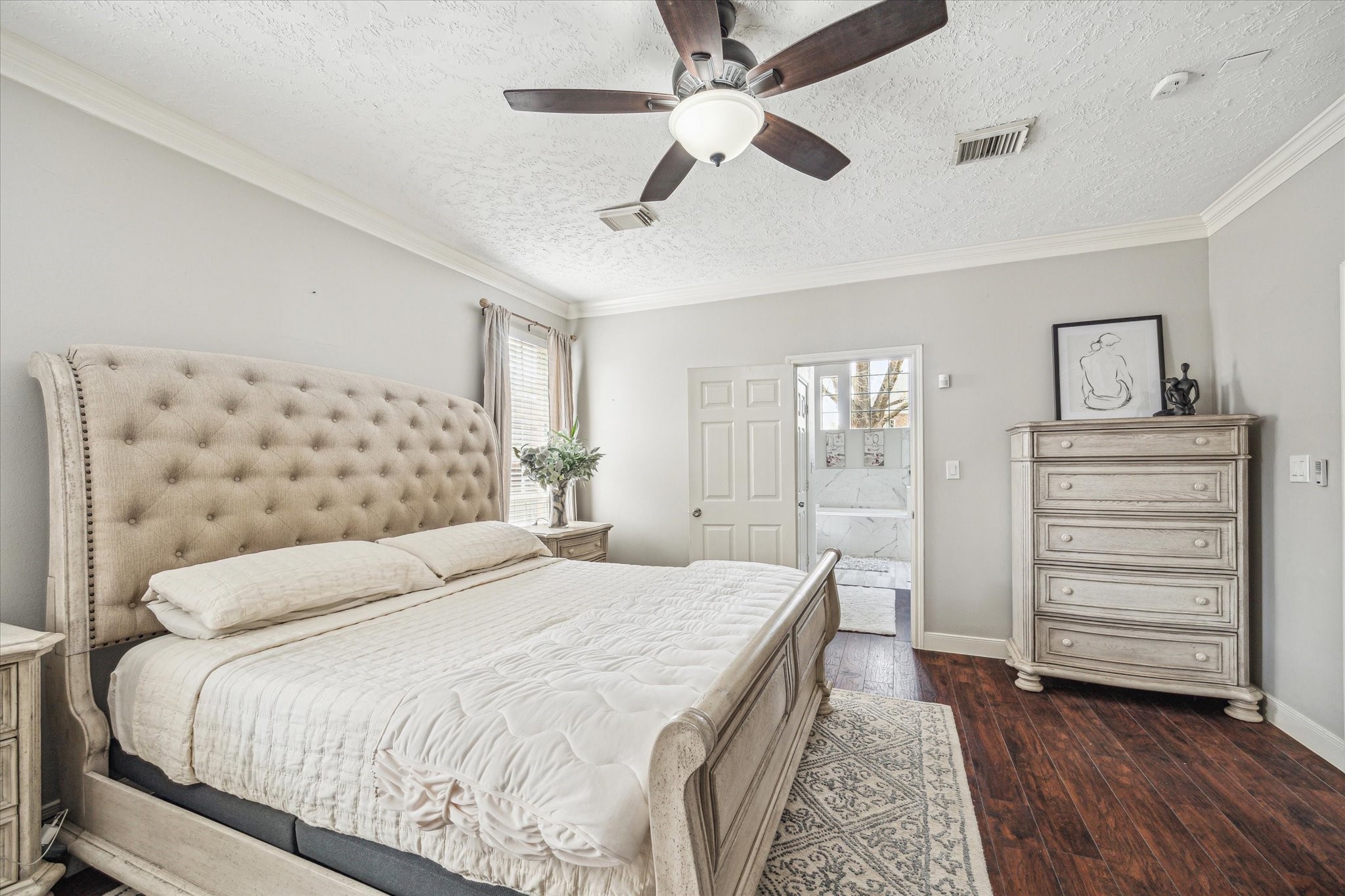 15314 Ripplewind Lane Houston, TX 77068 - Photo 12 of 24 a bedroom with a bed and a chandelier