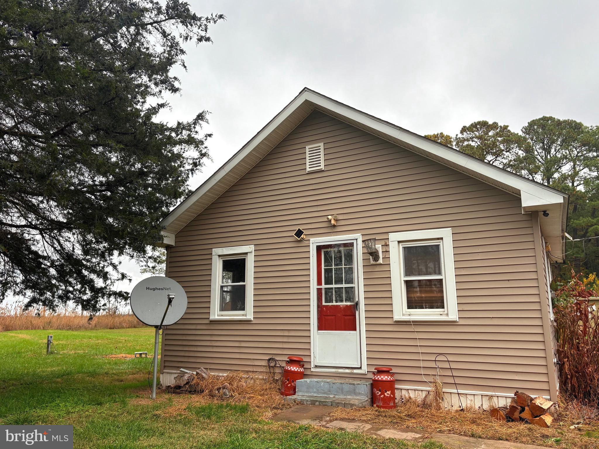 2145 Farm Creek Road Wingate, MD 21675 - Photo 1 of 24 a front view of a house with a yard