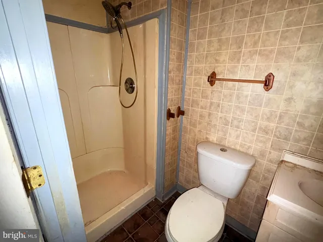 a bathroom with a toilet and shower