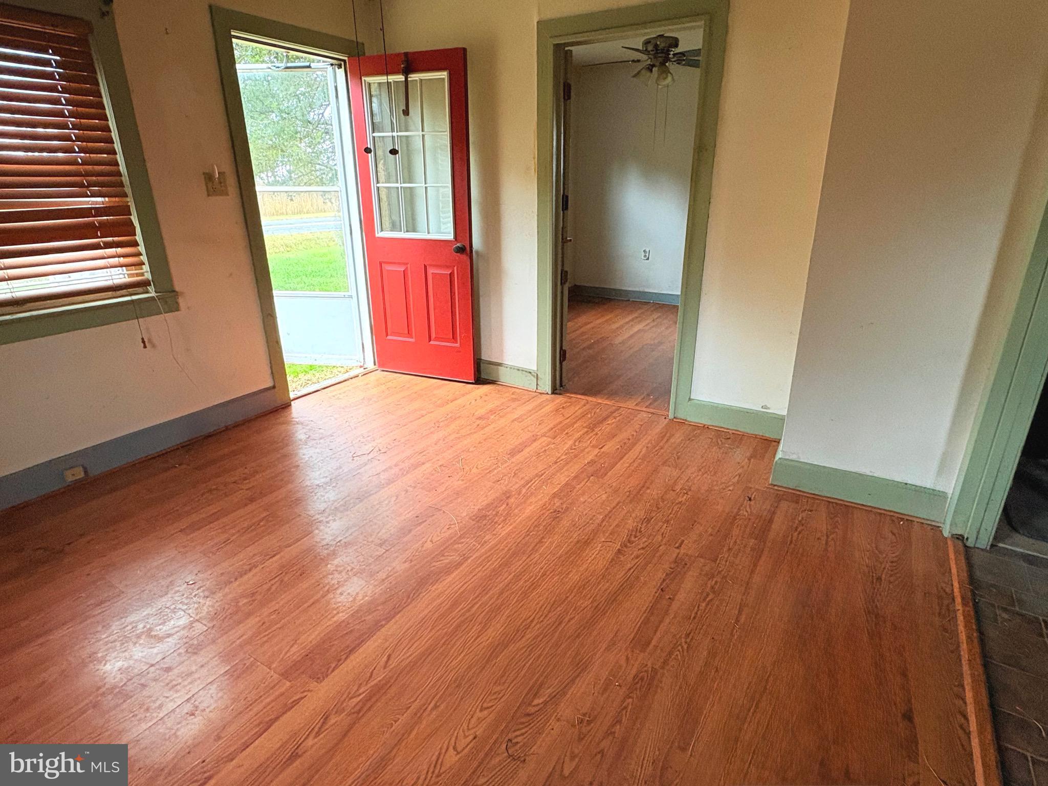2145 Farm Creek Road Wingate, MD 21675 - Photo 2 of 24 an empty room with wooden floor and windows