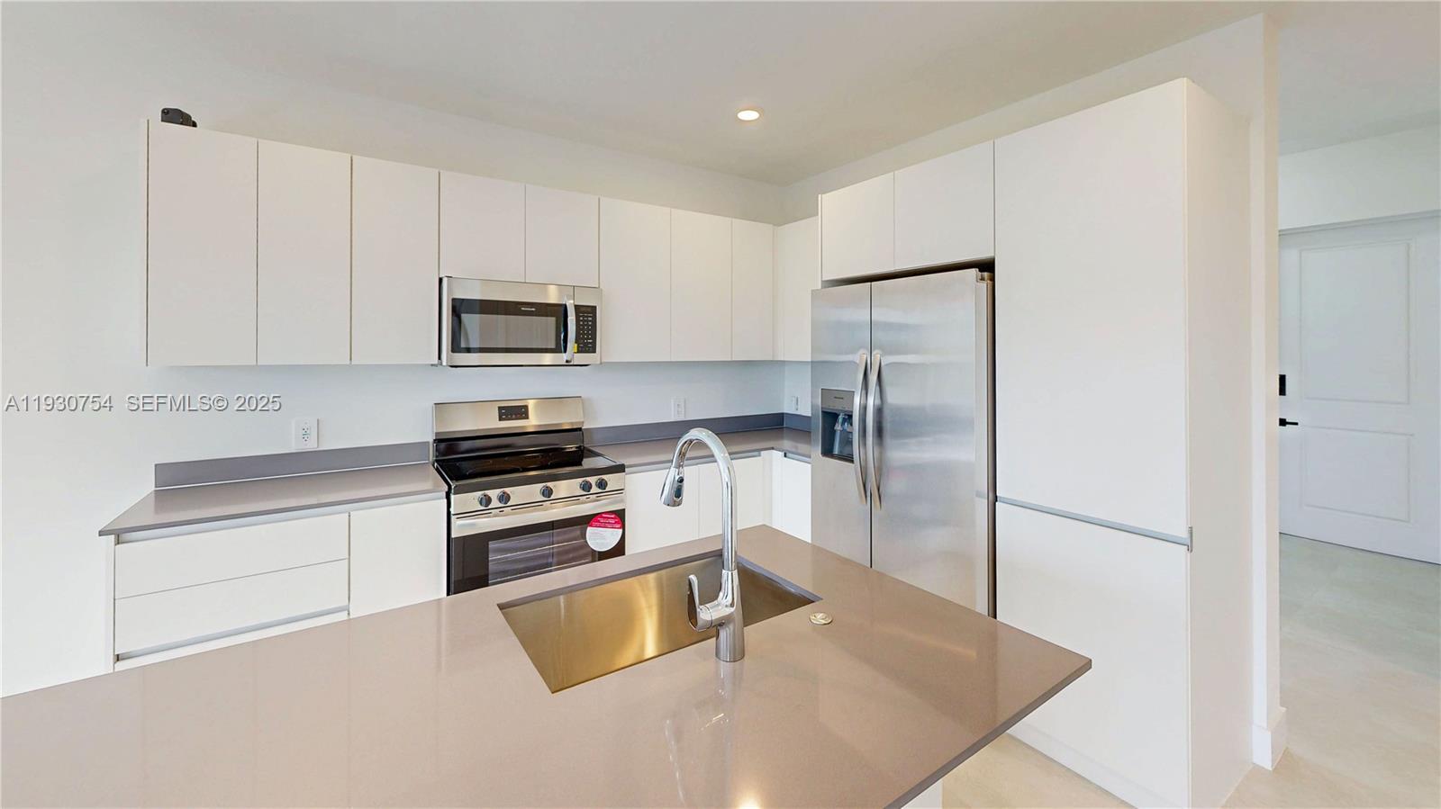 18936 Southwest 344th Terrace Homestead, FL 33034 - Photo 17 of 83 a kitchen with a refrigerator stove and microwave