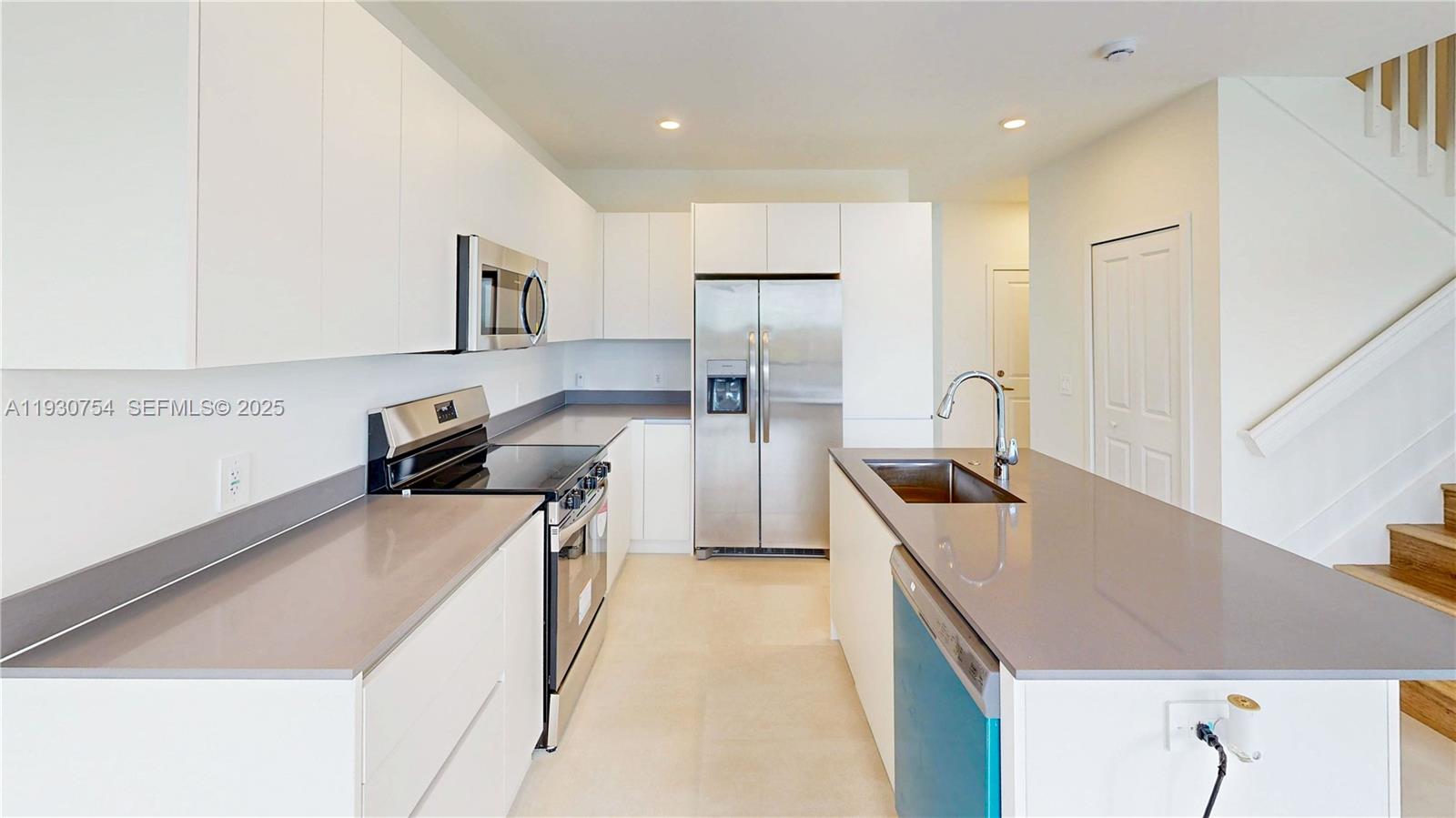 18936 Southwest 344th Terrace Homestead, FL 33034 - Photo 19 of 83 a kitchen with stainless steel appliances granite countertop a sink stove and refrigerator