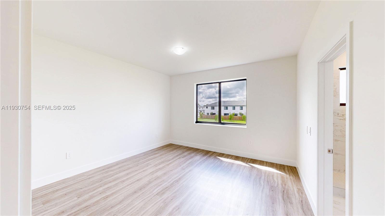 18936 Southwest 344th Terrace Homestead, FL 33034 - Photo 29 of 83 a view of an empty room with window and wooden floor