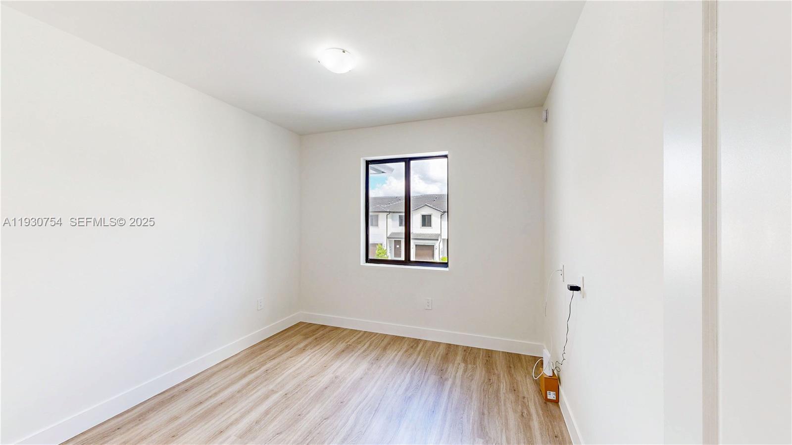 18936 Southwest 344th Terrace Homestead, FL 33034 - Photo 37 of 83 an empty room with wooden floor and windows