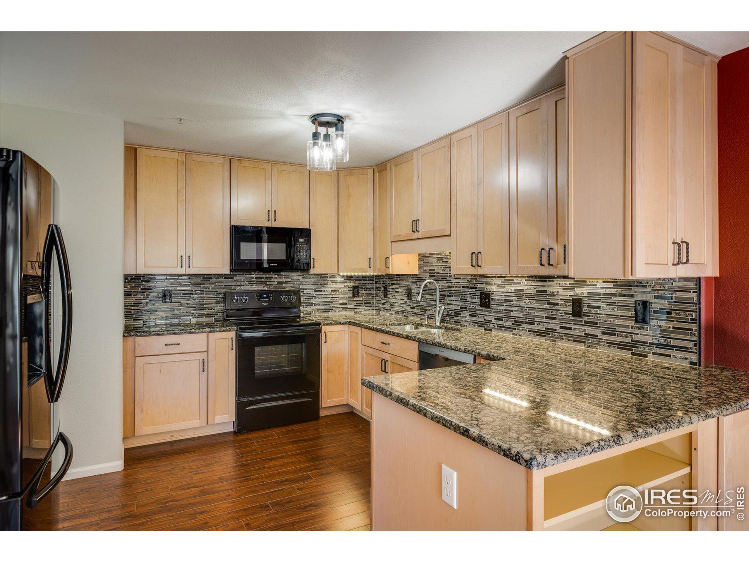 a kitchen with granite countertop a sink stainless steel appliances and counter space
