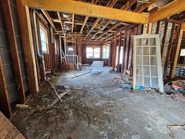 a view of a room with wooden floor