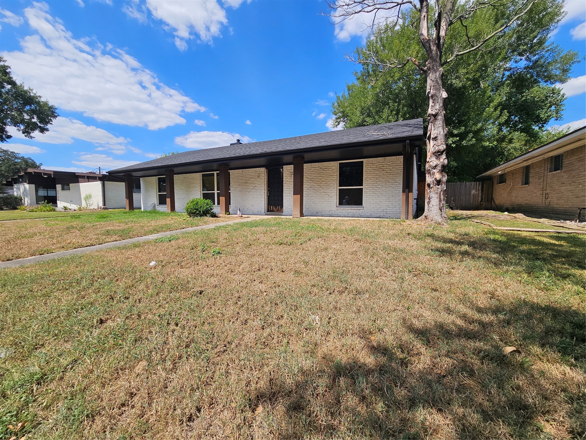 5706 Rutherglenn Drive Houston, TX 77096 - Photo 2 of 45 a front view of a house with a yard and garage