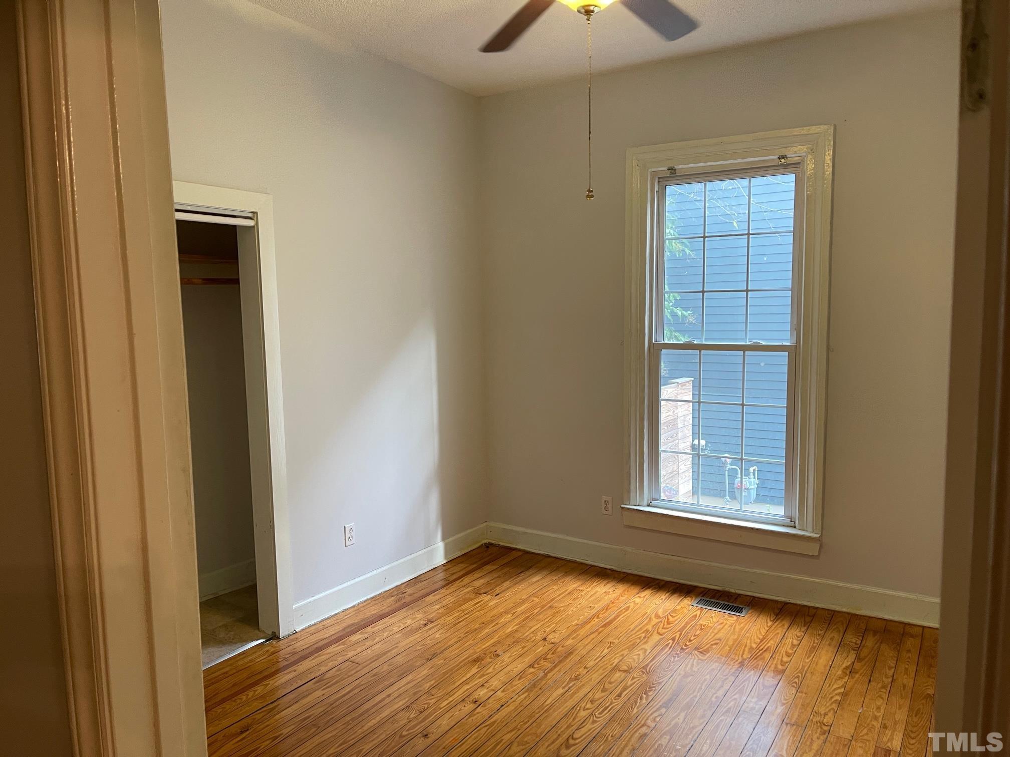 561 New Bern Avenue Raleigh, NC 27601 - Photo 11 of 15 an empty room with wooden floor and windows