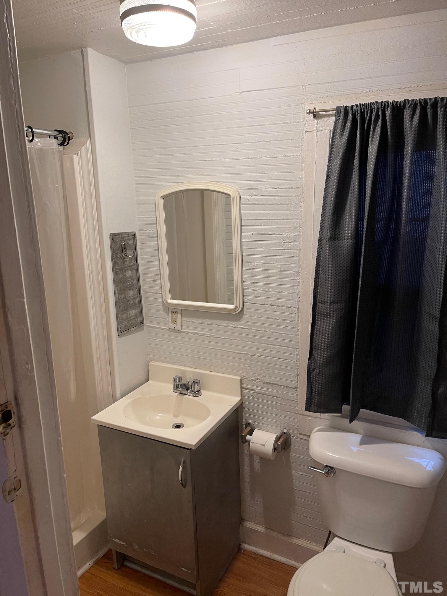 561 New Bern Avenue Raleigh, NC 27601 - Photo 12 of 15 a bathroom with a sink toilet and shower