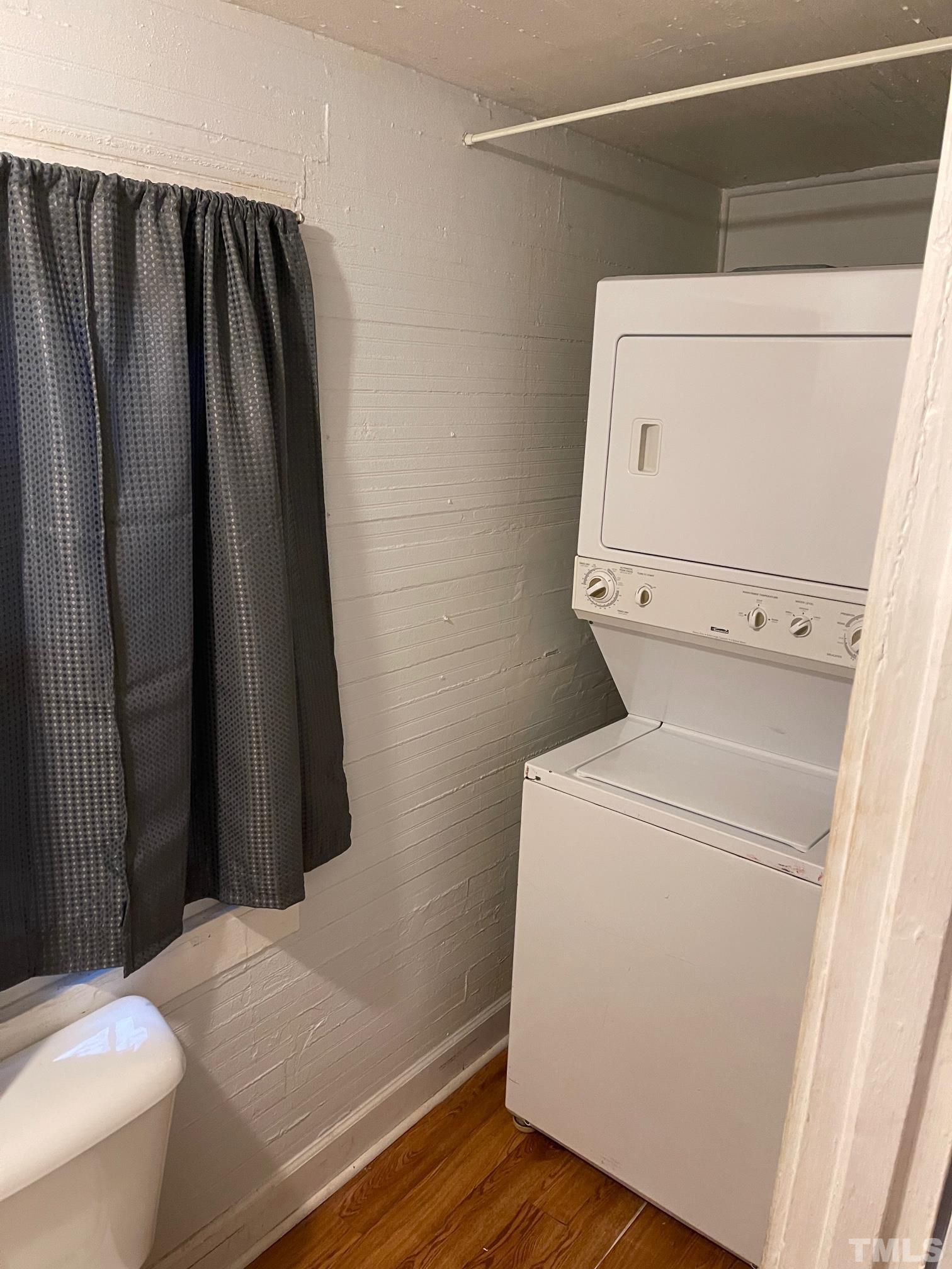 561 New Bern Avenue Raleigh, NC 27601 - Photo 13 of 15 a close view of a utility room with dryer and washer