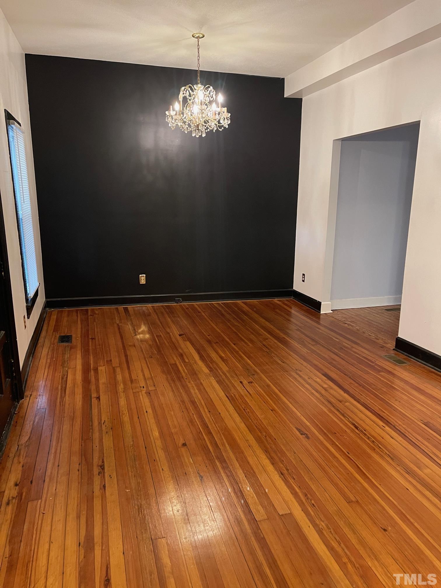 561 New Bern Avenue Raleigh, NC 27601 - Photo 4 of 15 a view of empty room with wooden floor and fan